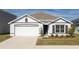 White and gray two-story house with a two-car garage and landscaped lawn at 5462 Logan Cave Ave, Wimauma, FL 33598