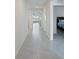 Bright hallway with tile floors leading to other rooms at 5462 Logan Cave Ave, Wimauma, FL 33598