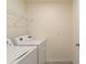 Laundry room with washer, dryer, and overhead shelving at 5462 Logan Cave Ave, Wimauma, FL 33598