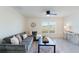 Living room with gray sectional sofa, coffee table, and large window at 5462 Logan Cave Ave, Wimauma, FL 33598