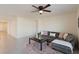 Living room with gray sectional sofa, coffee table, and ceiling fan at 5462 Logan Cave Ave, Wimauma, FL 33598