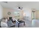 Living room with gray sectional sofa, coffee table, and large window at 5462 Logan Cave Ave, Wimauma, FL 33598