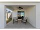 Covered patio with ceiling fan and seating at 5462 Logan Cave Ave, Wimauma, FL 33598