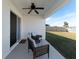Relaxing covered patio with seating area at 5462 Logan Cave Ave, Wimauma, FL 33598