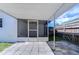 Backyard patio with screened enclosure and wooden fence at 5836 8Th St, Zephyrhills, FL 33542