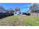 House backyard with a large yard and wooden fence at 5836 8Th St, Zephyrhills, FL 33542