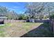 Large backyard with a wooden fence, storage shed, and ample space at 5836 8Th St, Zephyrhills, FL 33542