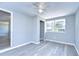 Simple bedroom with ceiling fan and large window at 5836 8Th St, Zephyrhills, FL 33542