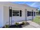 Inviting front porch with black accents and well-maintained landscaping at 5836 8Th St, Zephyrhills, FL 33542