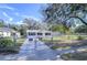 Newly renovated home with a spacious front yard and a chain link fence at 5836 8Th St, Zephyrhills, FL 33542