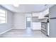 Modern kitchen with white cabinets, stainless steel appliances, and gray flooring at 5836 8Th St, Zephyrhills, FL 33542