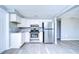 Renovated kitchen featuring white cabinets and stainless steel appliances at 5836 8Th St, Zephyrhills, FL 33542