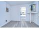 Bright laundry room with vinyl flooring and access to a screened porch at 5836 8Th St, Zephyrhills, FL 33542