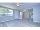 Open concept living area featuring light gray walls and vinyl plank flooring at 5836 8Th St, Zephyrhills, FL 33542