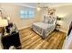 Cozy bedroom with a double bed, nightstands, and wood-look floors at 6188 80Th N St # 402, St Petersburg, FL 33709