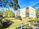 Building exterior with balconies and lake view at 6188 80Th N St # 402, St Petersburg, FL 33709