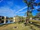 Community features a pond, lush landscape, and benches at 6188 80Th N St # 402, St Petersburg, FL 33709