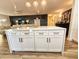 White kitchen island with marble countertop and gold hardware at 6188 80Th N St # 402, St Petersburg, FL 33709