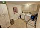 Bright laundry room with washer, dryer, and ample storage at 6188 80Th N St # 402, St Petersburg, FL 33709