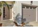 Townhome's front entrance with neutral-toned door and landscaping at 627 Vallance Ne Way, St Petersburg, FL 33716