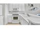 White kitchen with modern appliances and corner sink at 627 Vallance Ne Way, St Petersburg, FL 33716