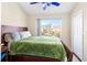 Bedroom with large bed and green blanket at 6333 Osprey Lake Cir, Riverview, FL 33578