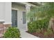 Modern gray front door with sidelights and stone accents at 6658 Dutton Dr, Wesley Chapel, FL 33545