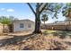 Large backyard with mature tree and wooden fence at 6811 S Hesperides St, Tampa, FL 33616