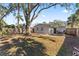 Large backyard with mature tree and wooden fence at 6811 S Hesperides St, Tampa, FL 33616