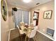 Modern dining area with glass table and four chairs at 6811 S Hesperides St, Tampa, FL 33616