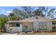 Charming brick home with a white picket fence and landscaped yard at 6811 S Hesperides St, Tampa, FL 33616