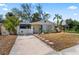 Charming single story home with white picket fence and blue door at 6811 S Hesperides St, Tampa, FL 33616