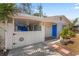 Front view of a charming house with a white picket fence and a blue door at 6811 S Hesperides St, Tampa, FL 33616