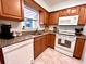 Well-equipped kitchen with modern appliances and wood cabinets at 6811 S Hesperides St, Tampa, FL 33616