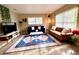 Bright living room featuring stylish sofas and a large TV at 6811 S Hesperides St, Tampa, FL 33616