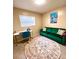 Home office features a comfortable couch, work desk, and stylish rug at 6811 S Hesperides St, Tampa, FL 33616