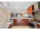Open kitchen with granite counters, island, and breakfast bar at 7200 Ulmerton Rd # E3, Largo, FL 33771