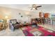 Bright living room with leather armchairs, a fireplace, and a large TV at 7200 Ulmerton Rd # E3, Largo, FL 33771