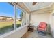 Bright sunroom with patio furniture and view at 7200 Ulmerton Rd # E3, Largo, FL 33771