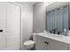 Bathroom with a white single sink vanity, black hardware, gray walls, and a framed mirror at 7320 Newhall Pass Ln, Wesley Chapel, FL 33545