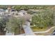 Aerial view of a single-Gathering home with a large yard and neighborhood in the background at 13029 Haverhill Dr, Spring Hill, FL 34609