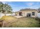 House exterior and backyard with patio and grill at 13029 Haverhill Dr, Spring Hill, FL 34609