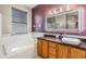 Bathroom features a soaking tub, updated vanity, and a modern mirror at 13029 Haverhill Dr, Spring Hill, FL 34609