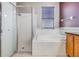 Bathroom with soaking tub, shower, and wood vanity at 13029 Haverhill Dr, Spring Hill, FL 34609