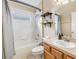 Clean bathroom with tub, shower, and wood cabinets at 13029 Haverhill Dr, Spring Hill, FL 34609