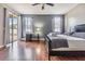 Main bedroom with wood floors, private access to backyard, and ceiling fan at 13029 Haverhill Dr, Spring Hill, FL 34609