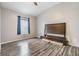 Spacious bedroom with wood flooring and large window at 13029 Haverhill Dr, Spring Hill, FL 34609