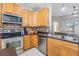 Updated kitchen, featuring stainless steel appliances and wood cabinets at 13029 Haverhill Dr, Spring Hill, FL 34609