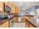 Kitchen boasts stainless steel appliances and ample wood cabinetry at 13029 Haverhill Dr, Spring Hill, FL 34609