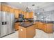 Spacious kitchen with island, stainless steel appliances, and wood cabinets at 13029 Haverhill Dr, Spring Hill, FL 34609
